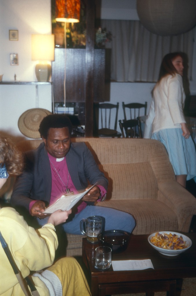 My sister talking with Bishop Amos Waiaru in our living room, with me in the background